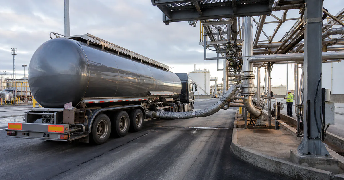 Insulated bitumen tanker being loaded safely at a modern refinery terminal